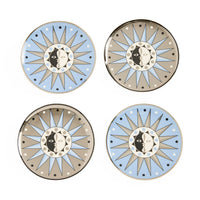 Four decorative plates with sun and moon designs on a white background