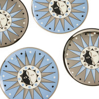 Decorative plates with sun and moon designs on a white background