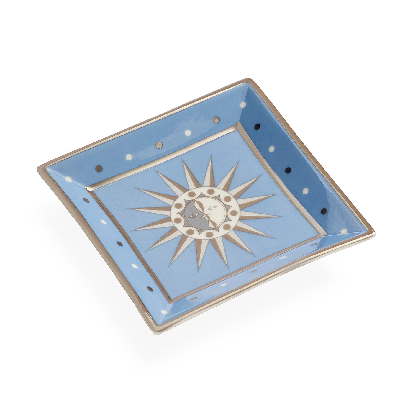 A square ceramic dish with a light blue glaze, featuring a central silver sunburst motif with a small moon and stars, and silver-rimmed edges with white and dark blue polka dots.