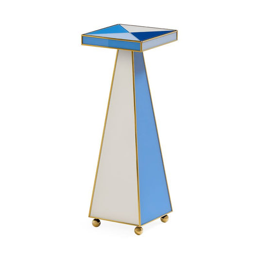 A modern geometric side table or pedestal with a tapered triangular base, a square top, and gold metal framing. The design features alternating panels of light blue, white, and blue on the top surface and base, finished with small gold caster wheels.