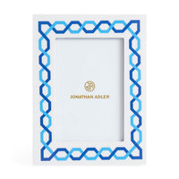 Decorative picture frame with blue geometric pattern and Jonathan Adler logo on a white background