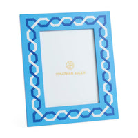 Blue decorative picture frame with white zigzag pattern on a white background