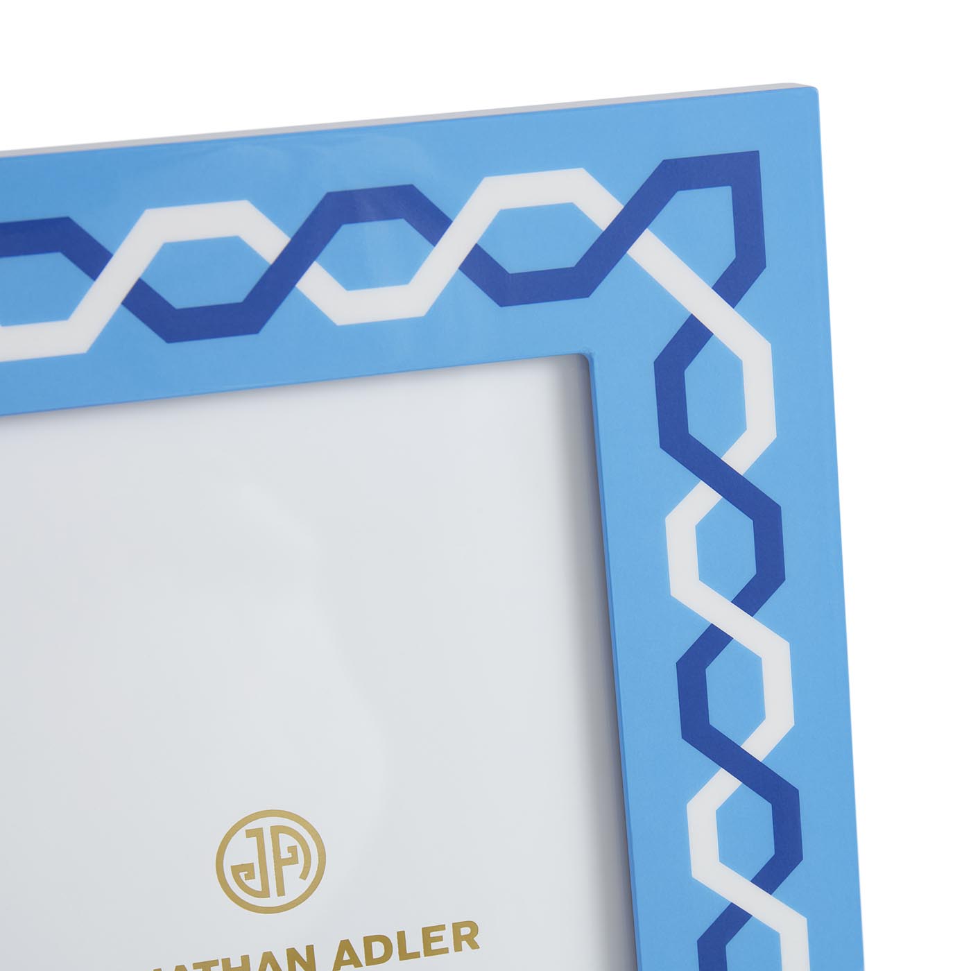 Blue decorative frame with white and blue geometric pattern, featuring the Nathan Adler logo.
