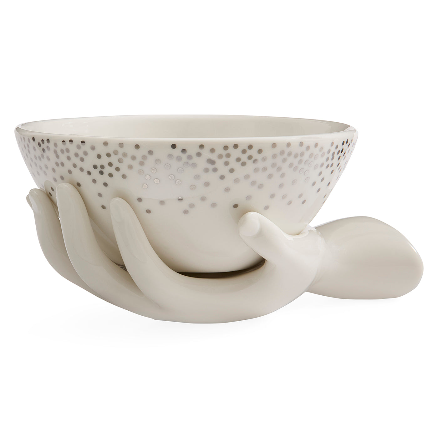 A ceramic bowl with a speckled pattern on the inside, supported by sculptural hands, on a solid white background.