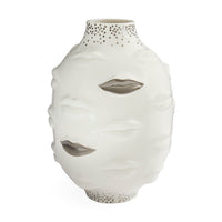 A white ceramic vase sculpted in the shape of a face with cutout eyes and mouth, featuring a dotted pattern on the neck and base, set against a plain white background.