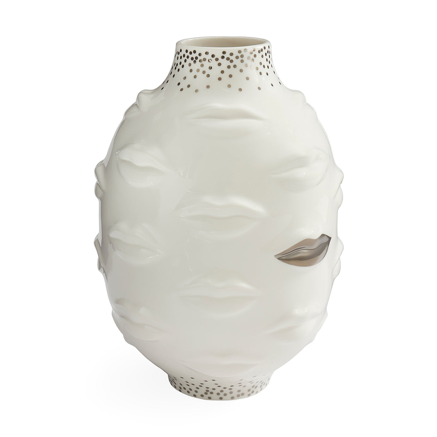 A white ceramic vase sculpted with a stylized face, featuring textured lips, closed eyes, and a metallic silver leaf detail on one eye. The neck and base are decorated with small metallic gold dots, set against a plain white background.