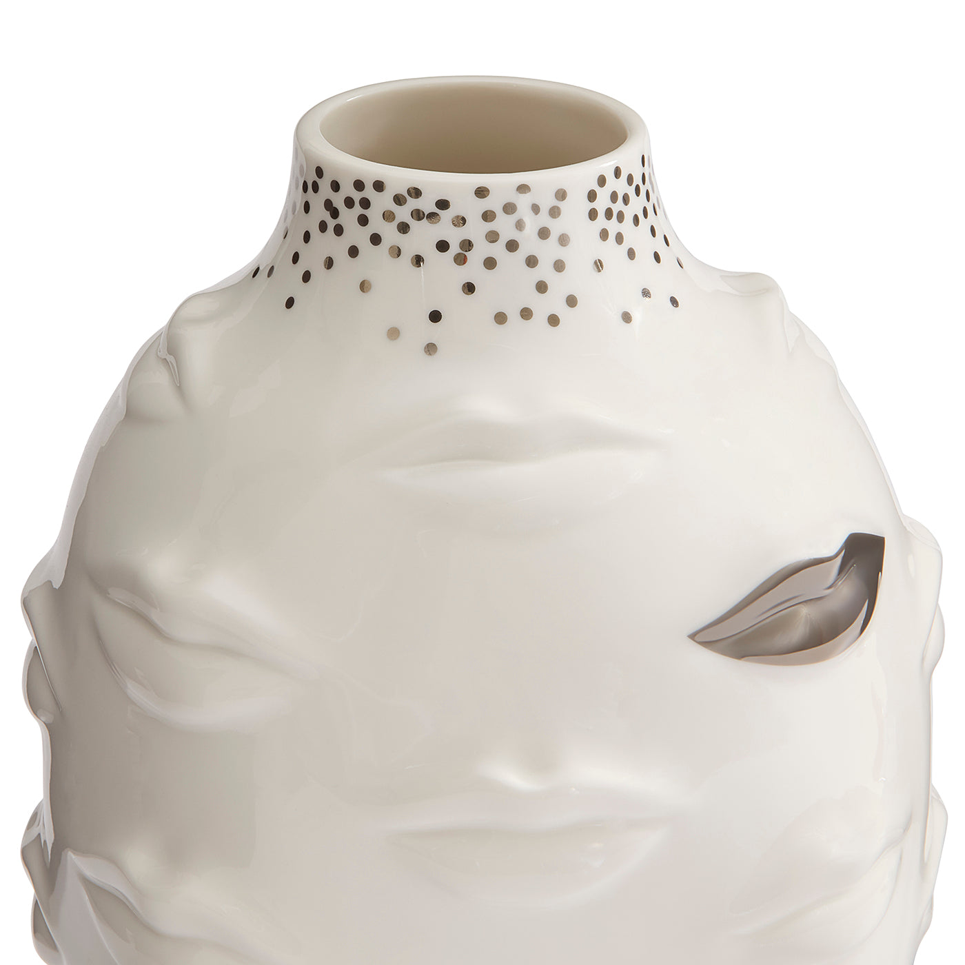 A sculptural ceramic vase shaped like a stylized face, in glossy off-white with a metallic silver leaf detail on the cheek and a dotted pattern around the neck, shown on a white background.
