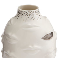 A sculptural ceramic vase shaped like a stylized face, in glossy off-white with a metallic silver leaf detail on the cheek and a dotted pattern around the neck, shown on a white background.