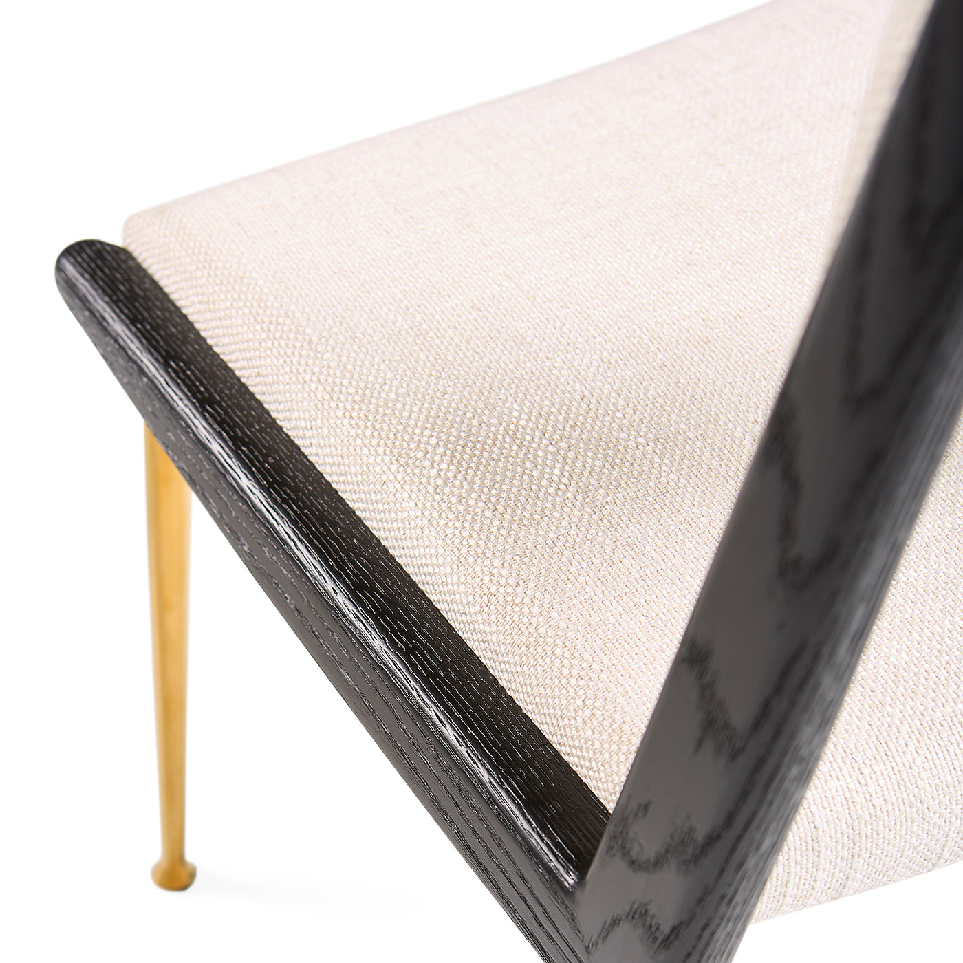 Close-up of a chair with black frame and beige cushion on a white background