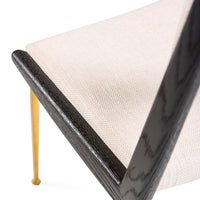 Close-up of a chair with black frame and beige cushion on a white background