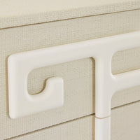 Close-up of a beige textured surface with a white handle and leg.