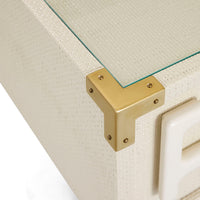Close-up of a gold corner bracket on a white textured surface