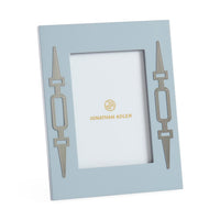 Light blue picture frame with decorative elements and 'Jonathan Adler' branding on a white background