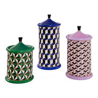 Three ceramic jars with geometric patterns and colorful lids on a white background