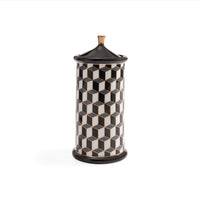 A cylindrical lidded container with a black and white 3D geometric cube pattern and a small gold-toned top knob, shown on a plain white background.