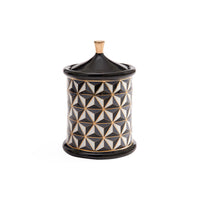 A cylindrical decorative container with a matching lid, featuring a black, white, and gold geometric pattern on the body and a solid black lid and base with a small gold finial on top, set against a plain white background.